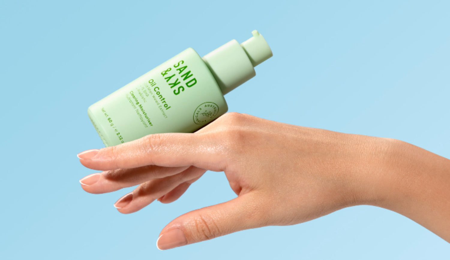 clearing moisturiser bottle balancing on hand